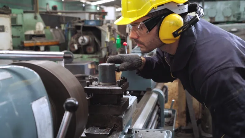 Machinist on a factory floor: manufacturing time tracking